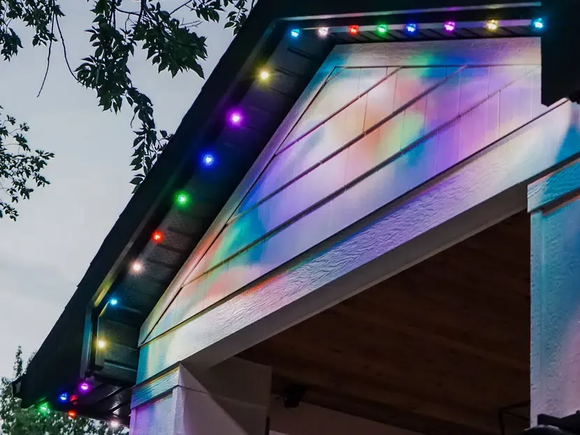 Close view of a gable with multicolored lights set in a slim track under the roof edge