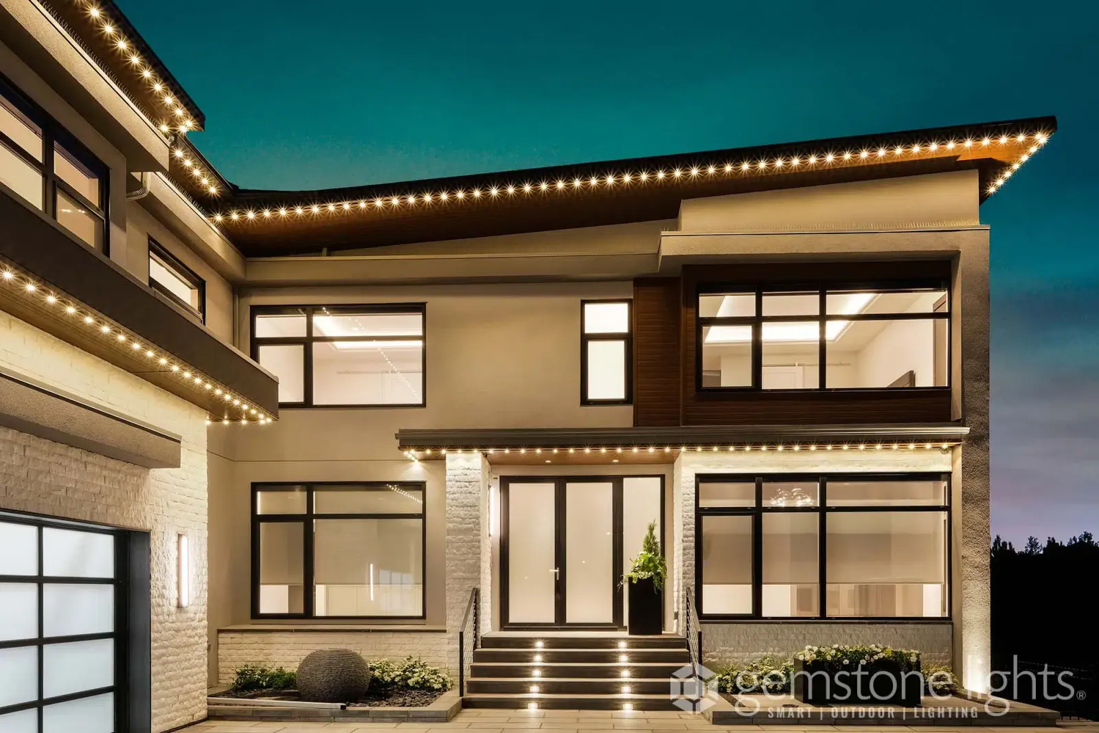 Contemporary home outlined in warm white light