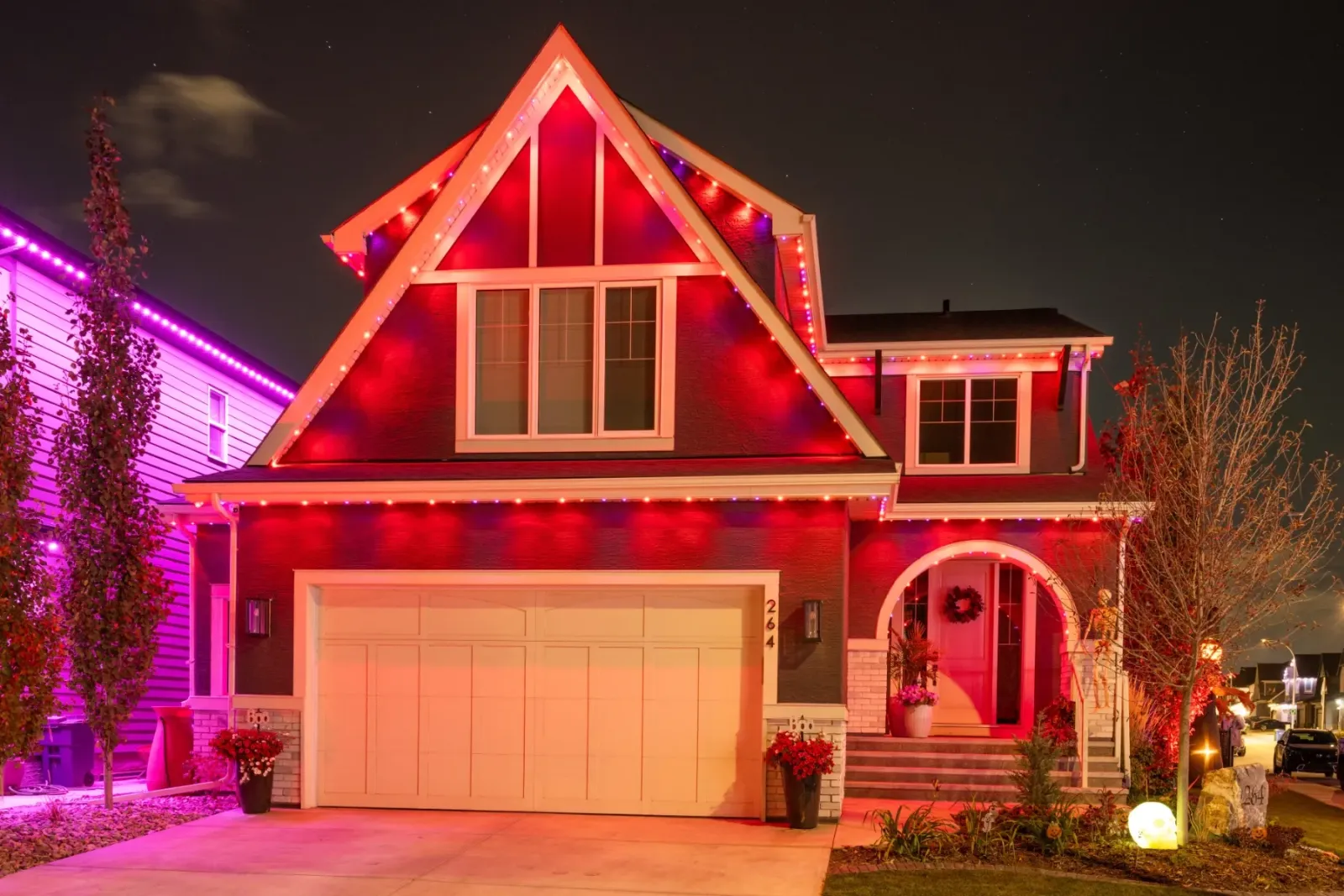 House lit deep orange-red for Halloween